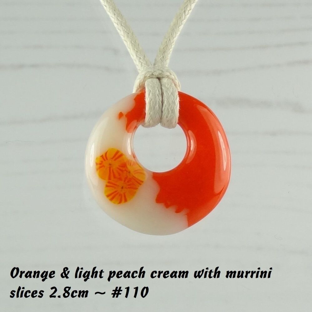 Handcrafted orange & light peach cream with murrini slices fused glass off-set round pendant on a waxed cotton cord with lobster clasp (#110)