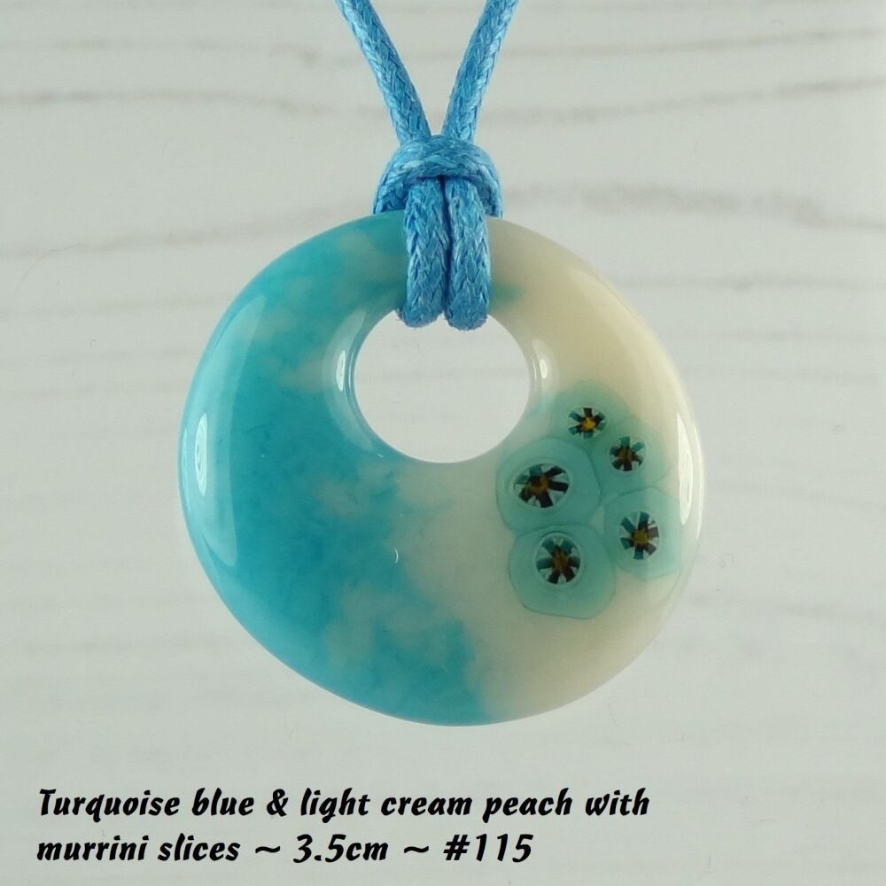 Handcrafted turquoise blue & light peach cream with murrini slices fused glass off-set round pendant on a waxed cotton cord with lobster clasp (#115)