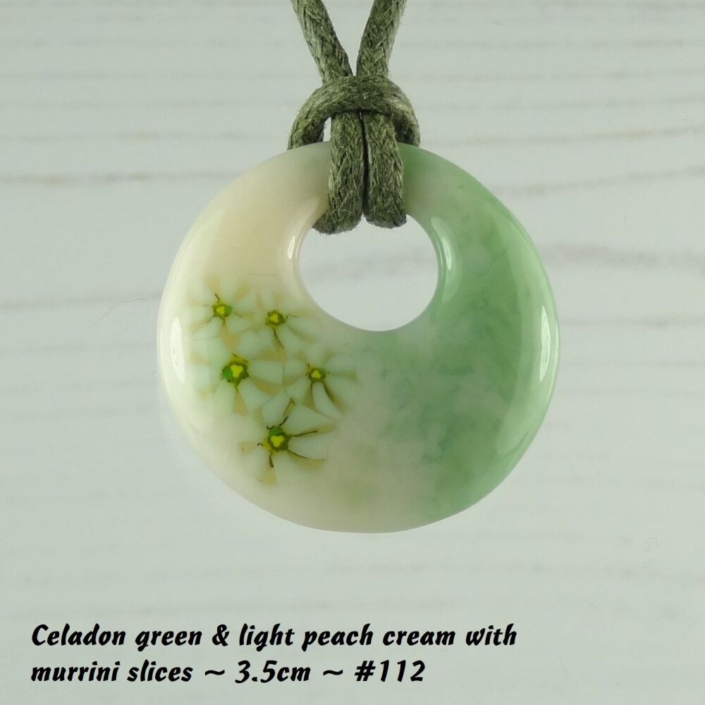 Handcrafted celadon green & light peach cream with murrini slices fused glass off-set round pendant on a waxed cotton cord with lobster clasp (#112)