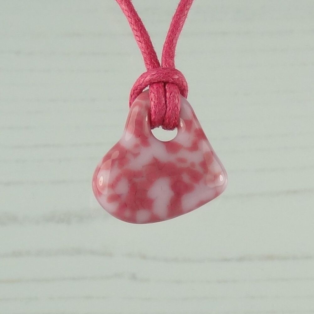 Handcrafted fused glass pink off-set heart shaped pendant on a waxed cotton