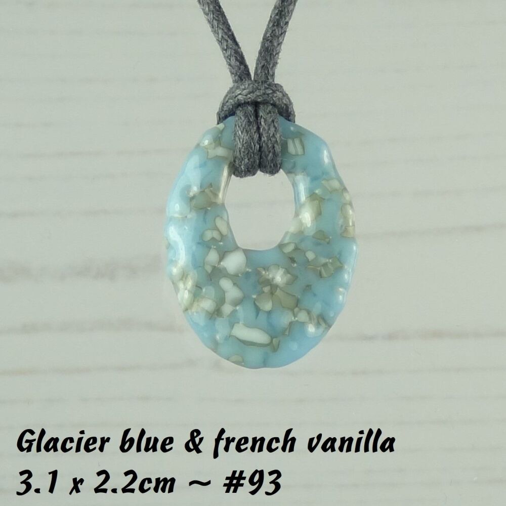 Handcrafted glacier blue & french vanilla fused glass off-set oval pendant on a waxed cotton cord with lobster clasp (#93)