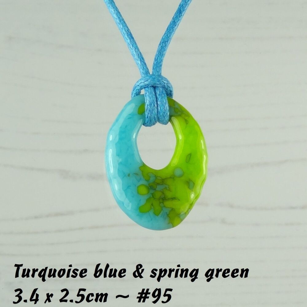 Handcrafted turquoise blue & spring green fused glass off-set oval pendant on a waxed cotton cord with lobster clasp (#95)