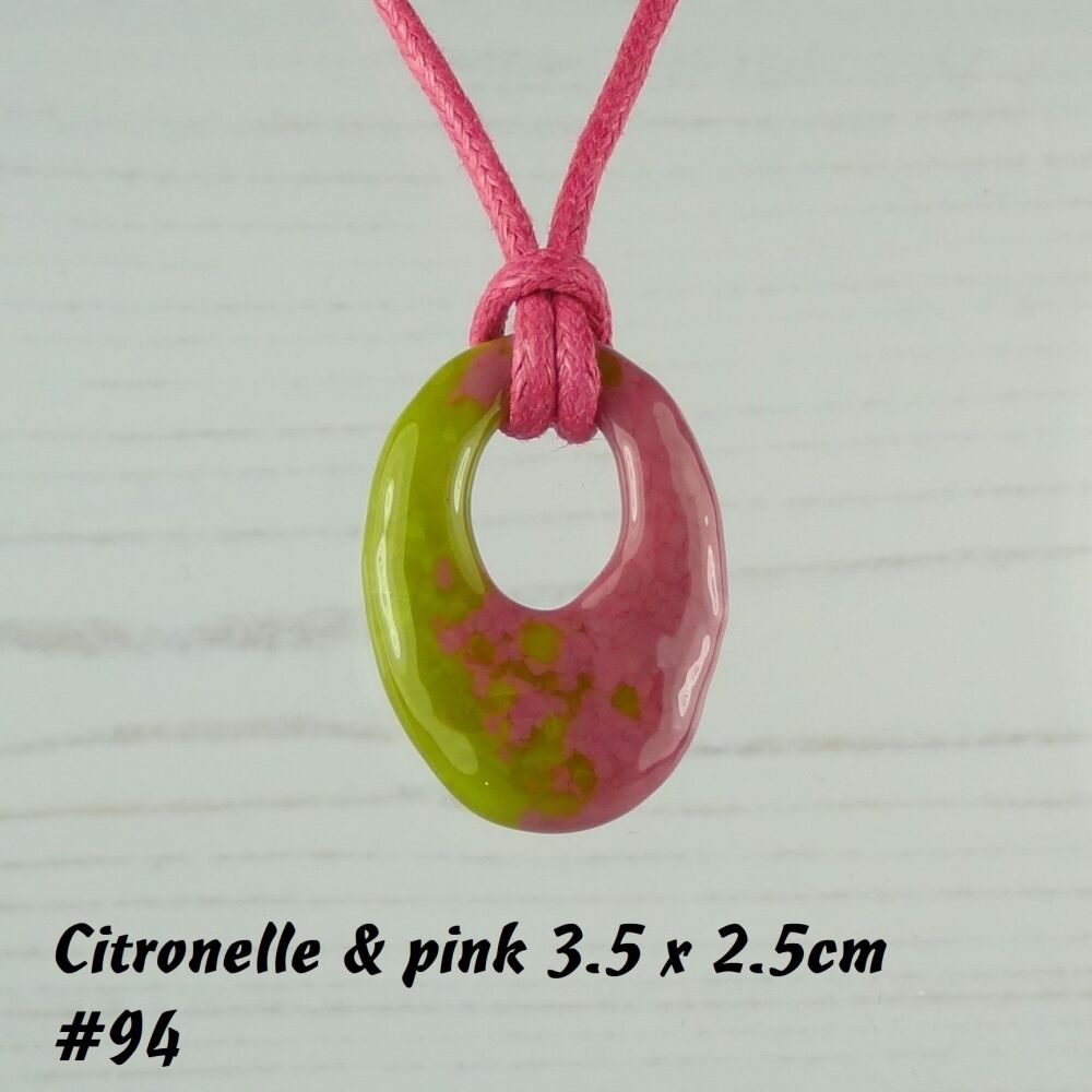 Handcrafted citronelle & pink fused glass off-set oval pendant on a waxed cotton cord with lobster clasp (#94)