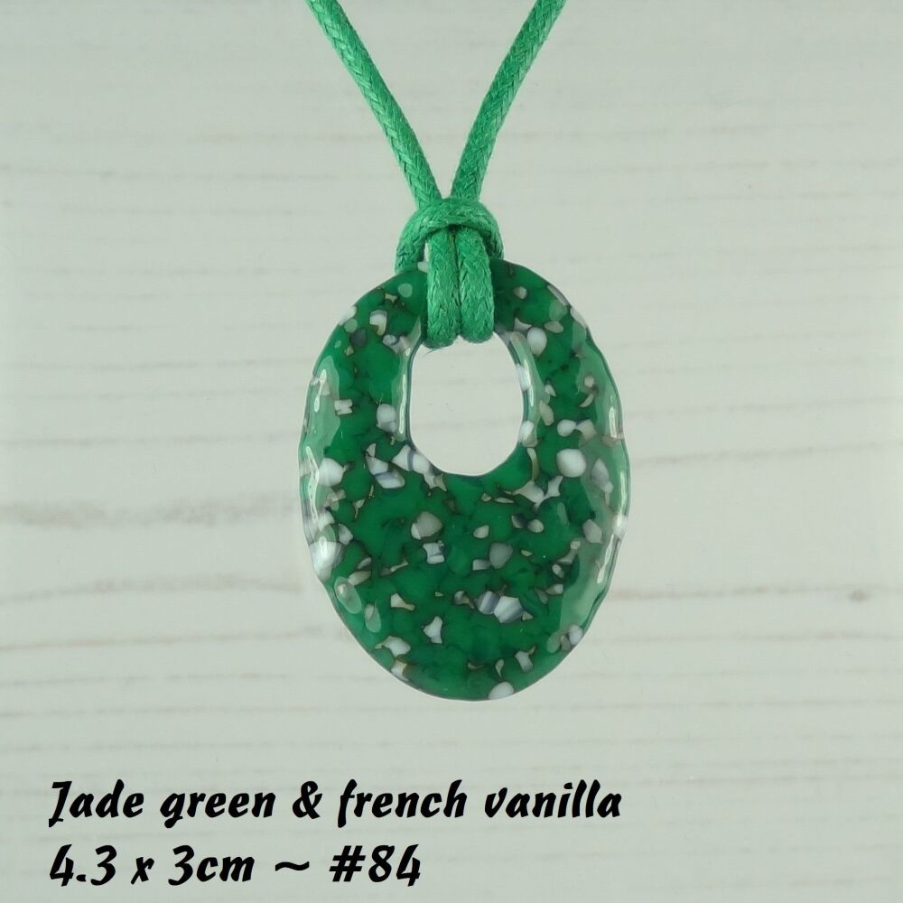 Handcrafted jade green & french vanilla fused glass off-set oval pendant on a waxed cotton cord with lobster clasp (#84)