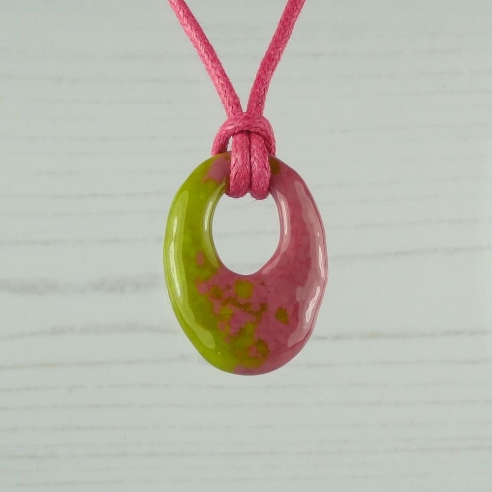 Handcrafted citronelle & pink fused glass off-set oval pendant on a waxed c