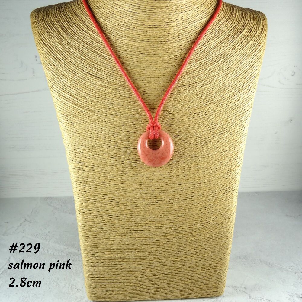 Handcrafted salmon pink fused glass off-set round pendant on a waxed cotton cord with lobster clasp (#229)