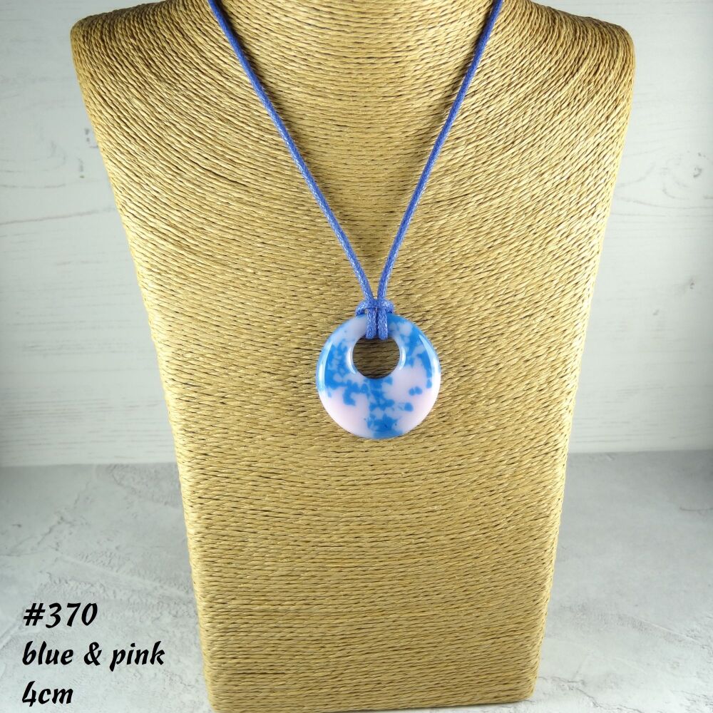 Handcrafted pink & blue fused glass off-set round pendant on a waxed cotton cord with lobster clasp (#370)