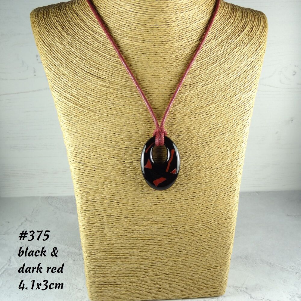 Handcrafted black & dark red fused glass off-set oval pendant on a waxed cotton cord with lobster clasp (#375)