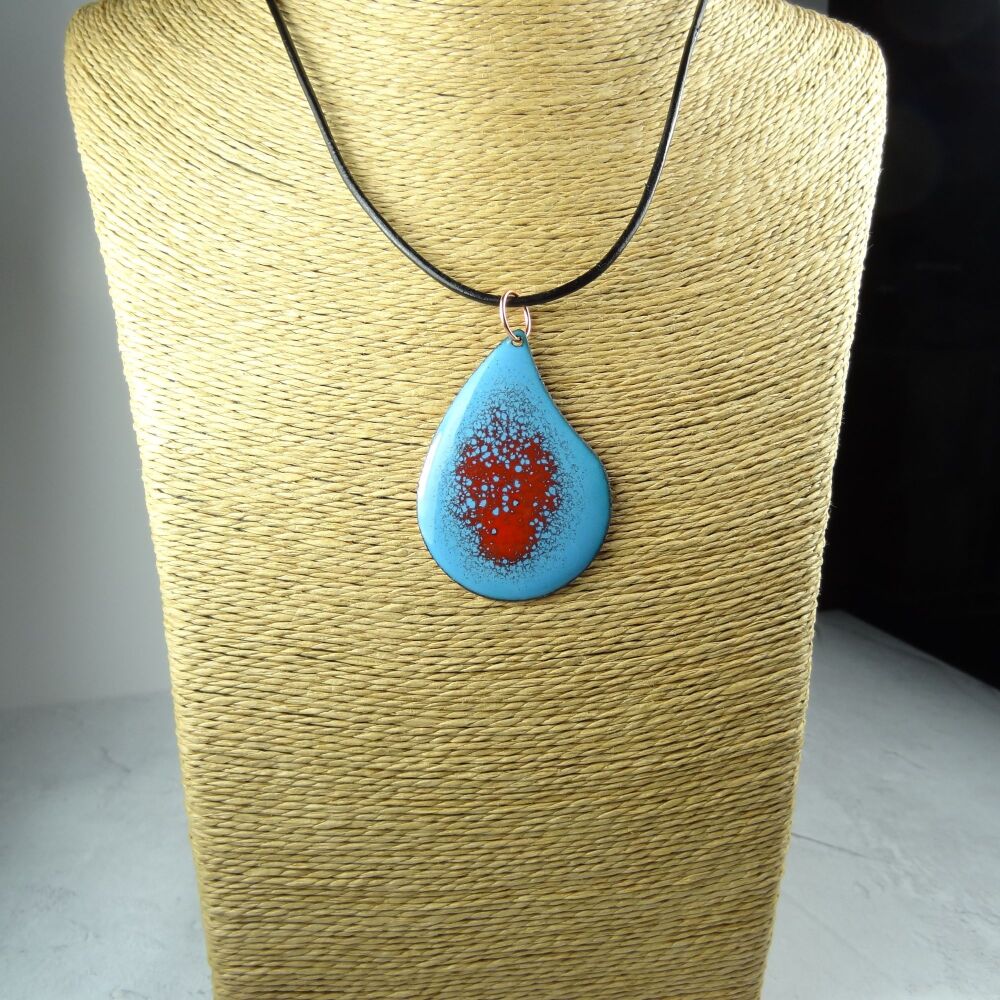 Handcrafted blue and red glass enamelled copper teardrop shaped 51x36mm pendant, on an 18 inch black leather cord with lobster clasp (#0077)