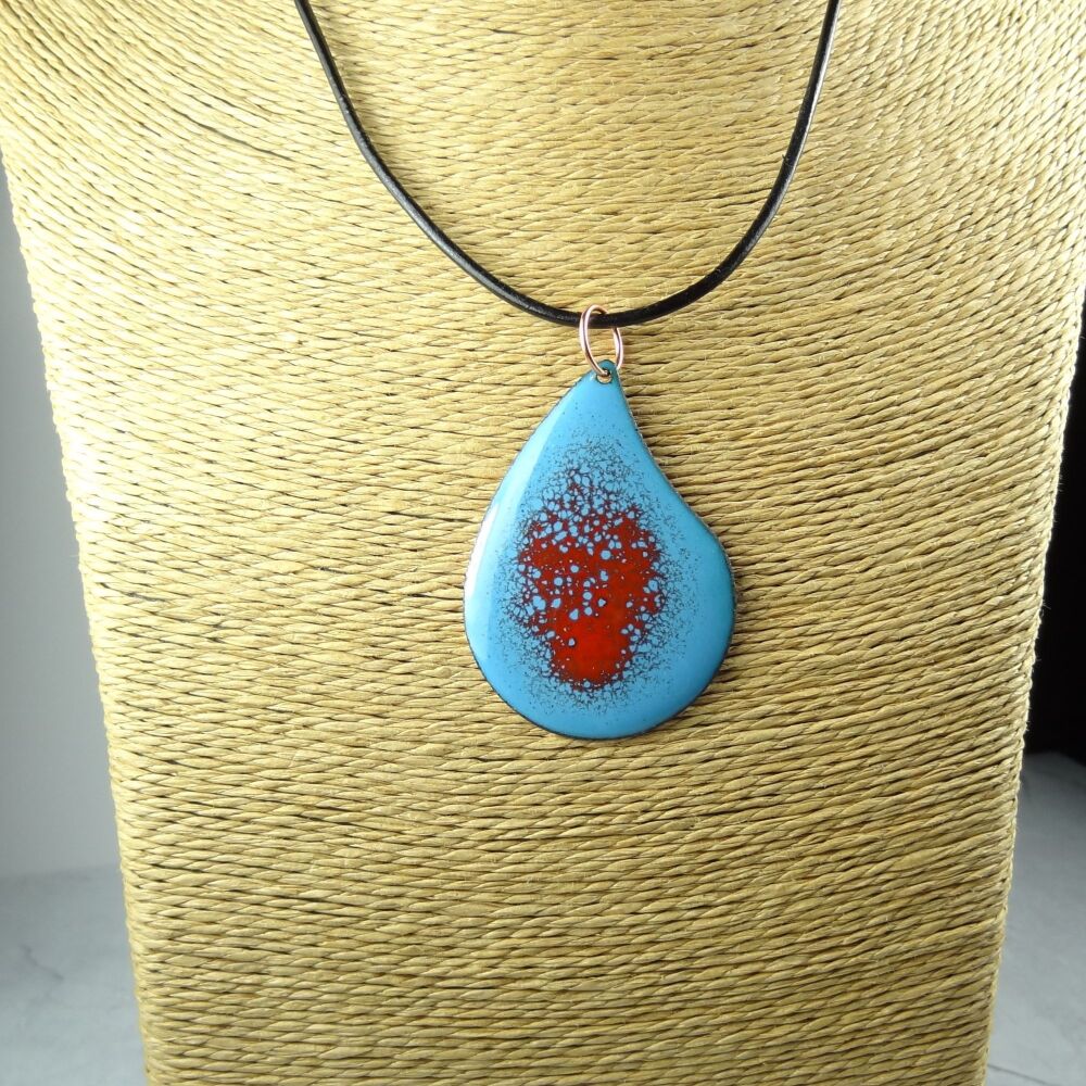 Handcrafted blue and red glass enamelled copper teardrop shaped 51x36mm pendant, on an 18 inch black leather cord with lobster clasp (#0077)