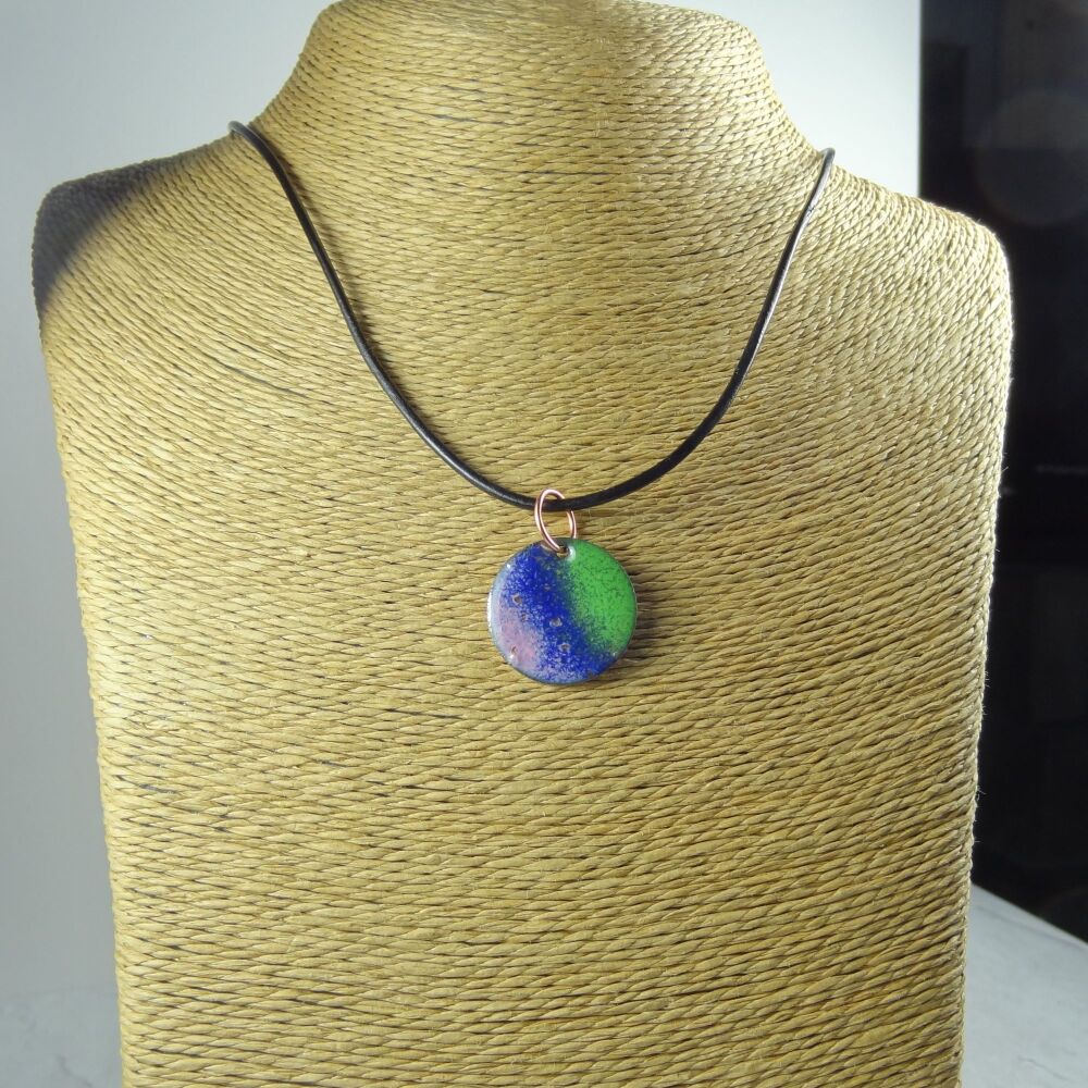 Handcrafted green blue and pink glass enamelled copper 22mm disc pendant, on an 18 inch black leather cord with lobster clasp (#0111)
