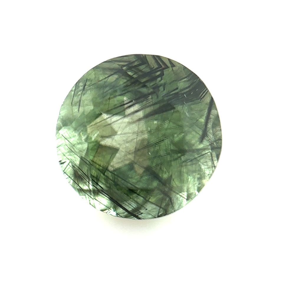 Peridot faceted gem with Ludwigite inclusions - 4528