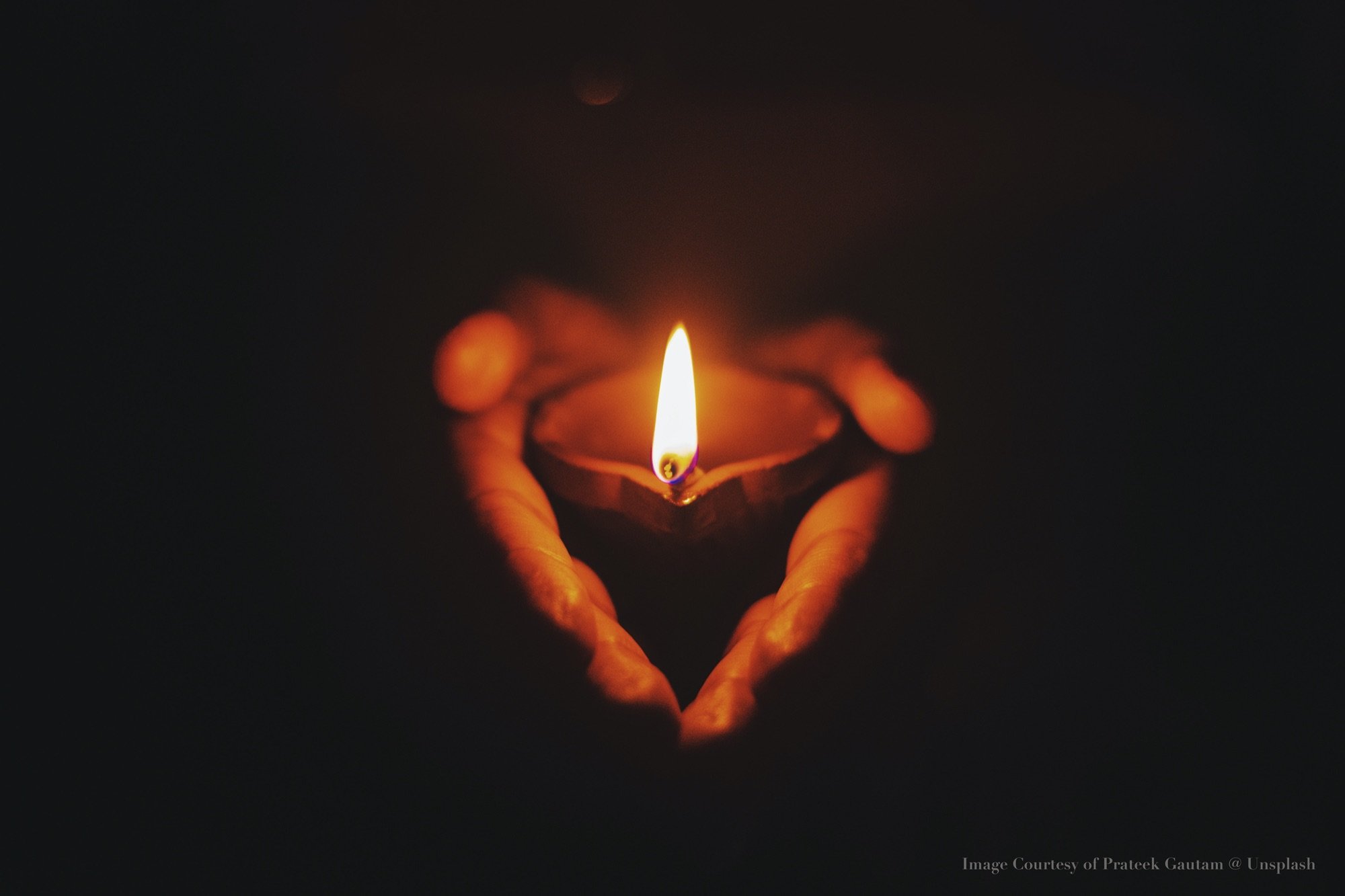 Hands holding a candle photograph by Pateek  Gautam on Unsplash