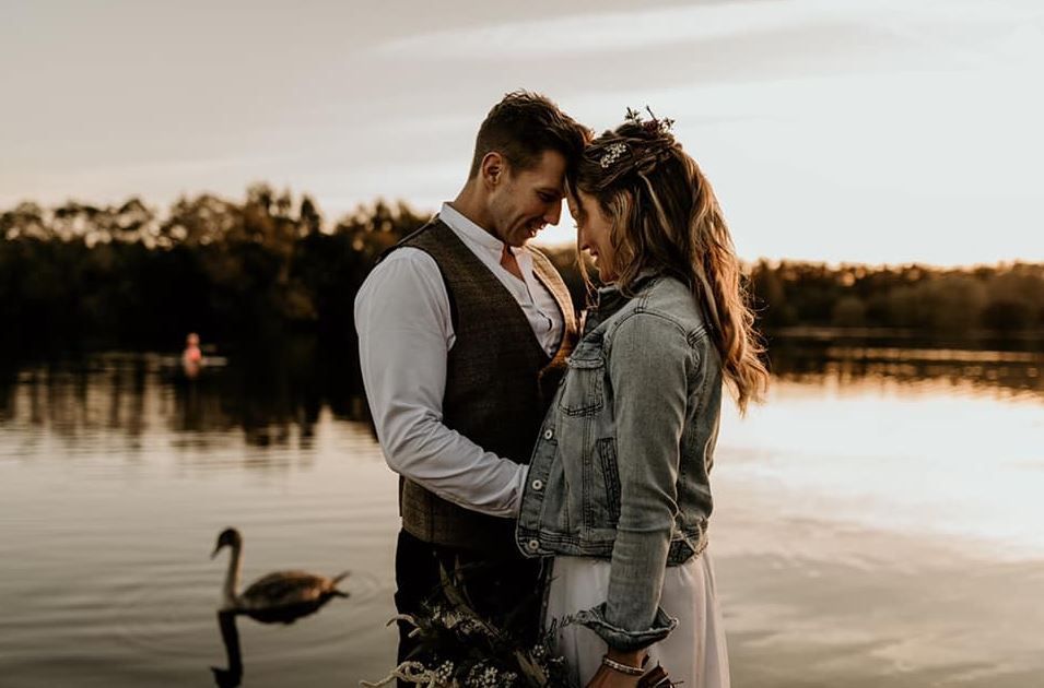 Boho bride & groom on a lake