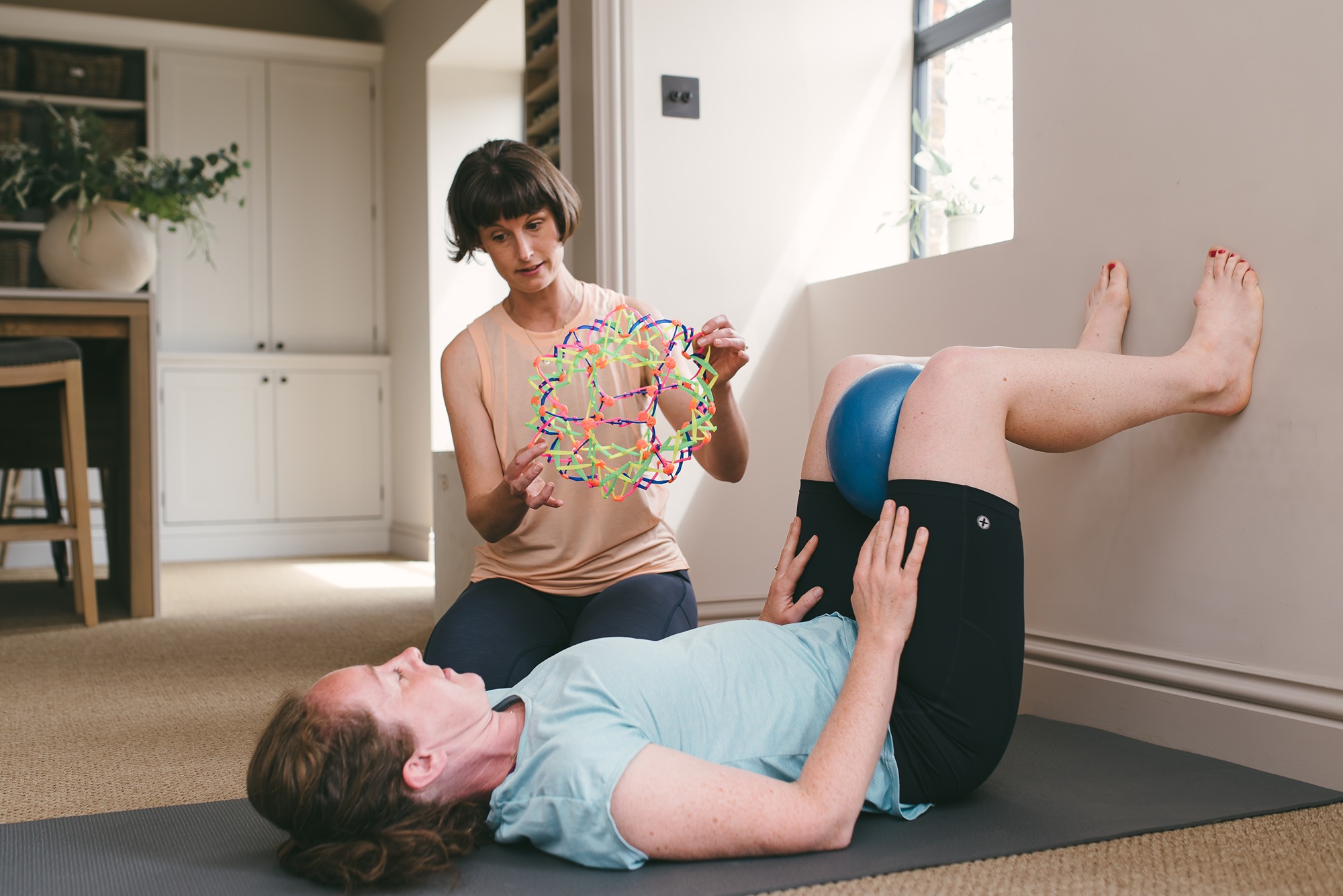 female learning diaghragmatic breathing for pelvic organ prolapse and leaking