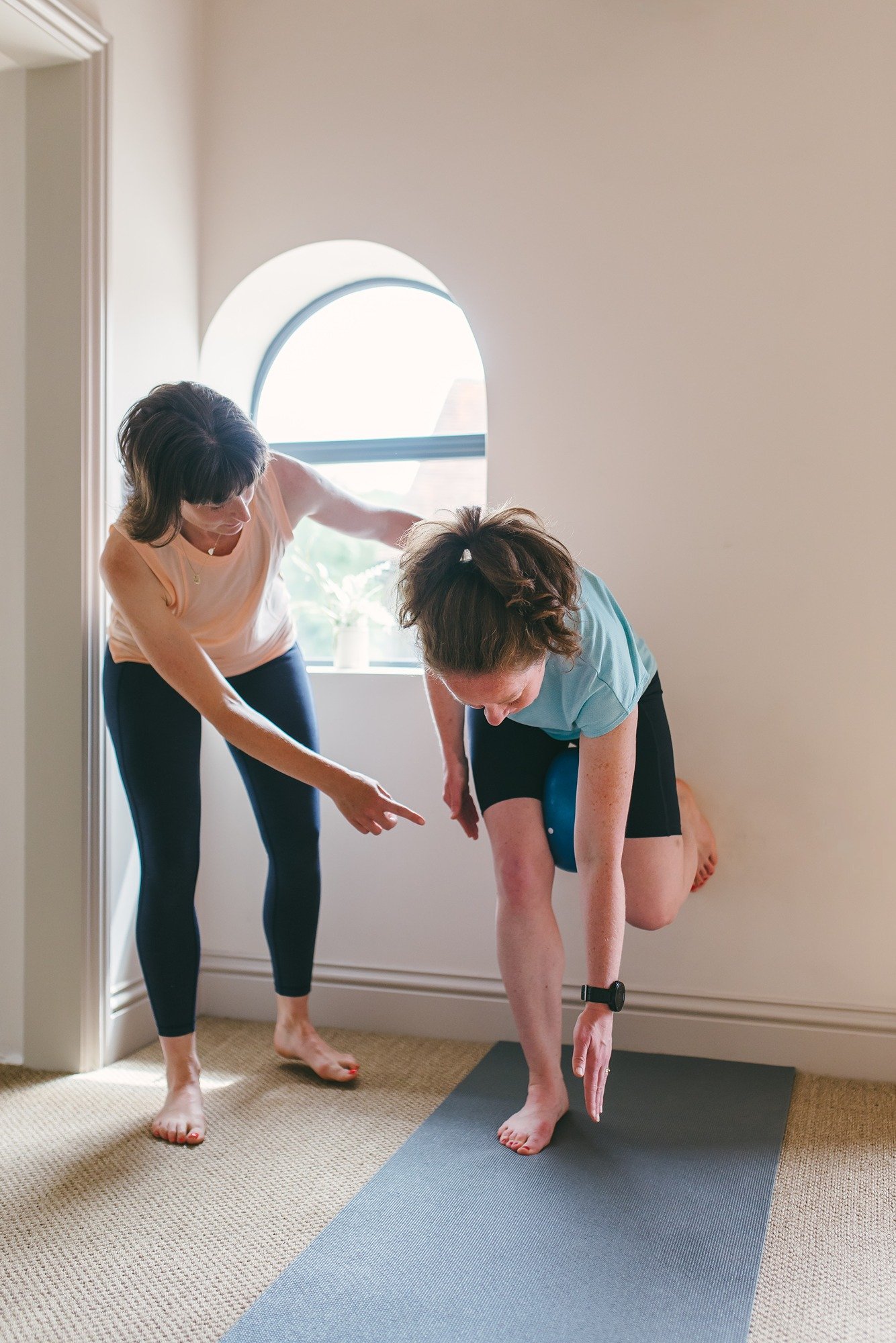 Woman performing hip stability exercise under corrective exercise coaching