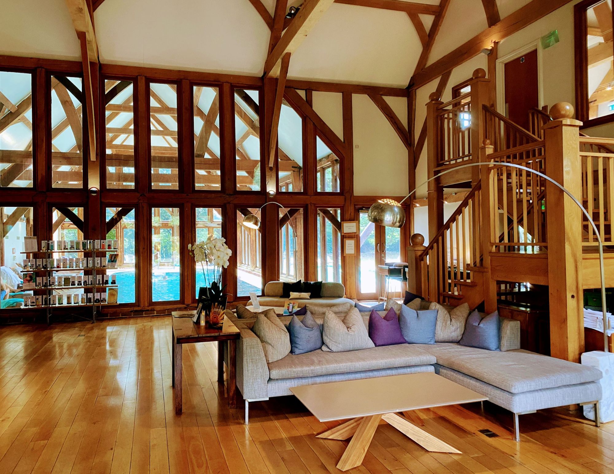 Beautiful entrance hall with oak beams and oak surround windows through to an indoor swimming pool