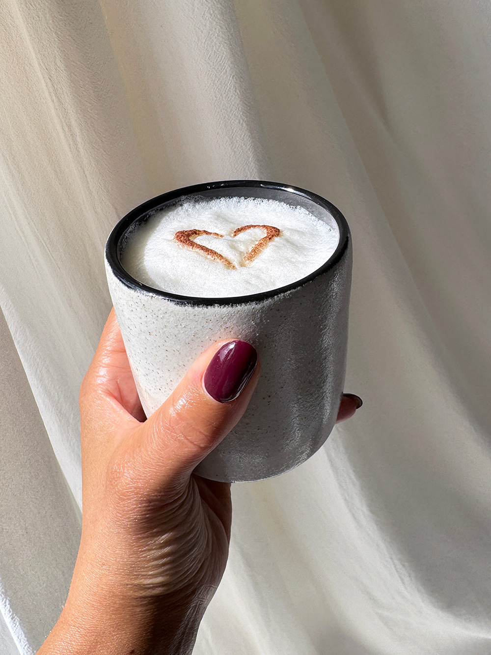 milk cup held small.jpg