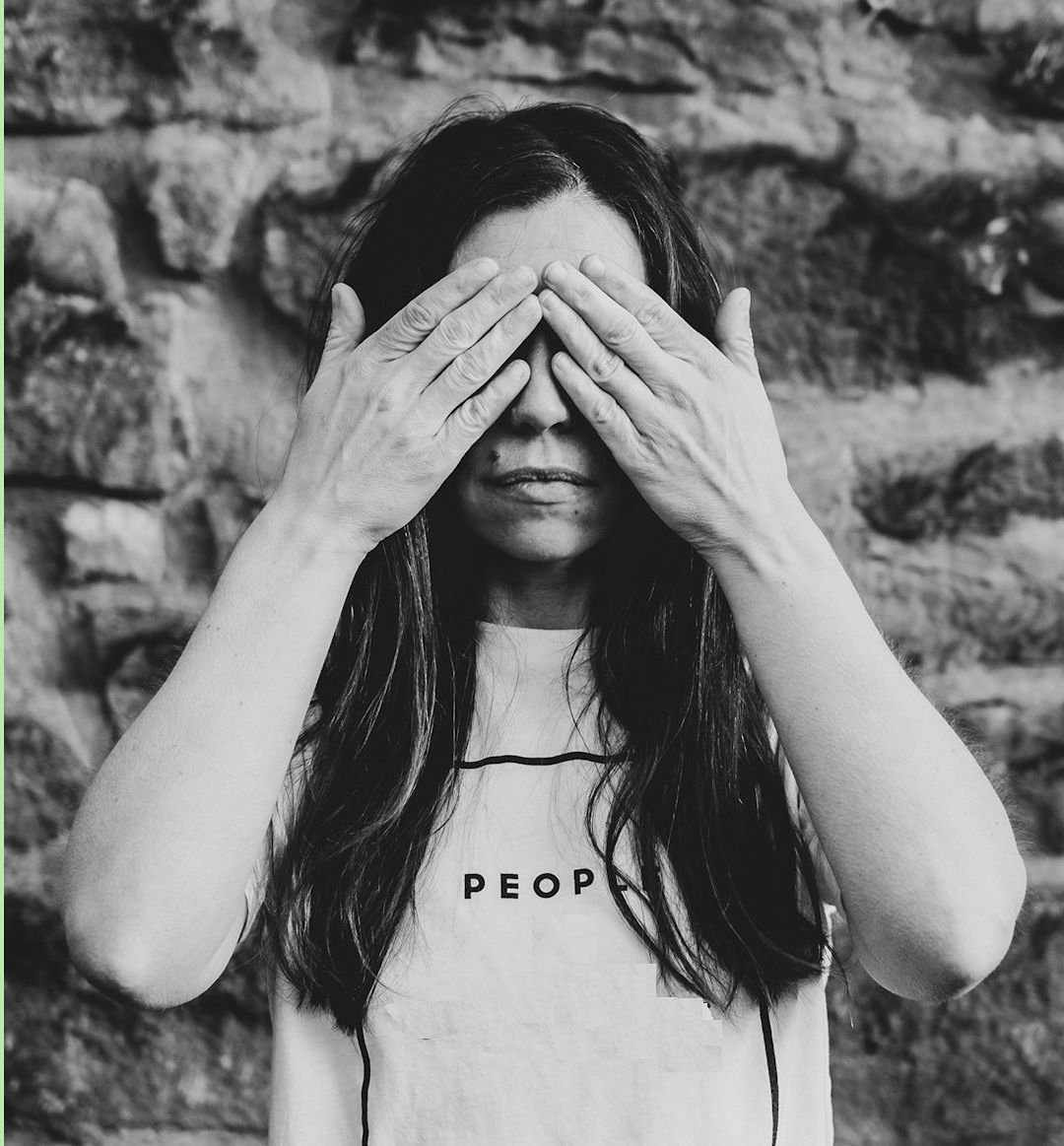 image of woman covering her eyes