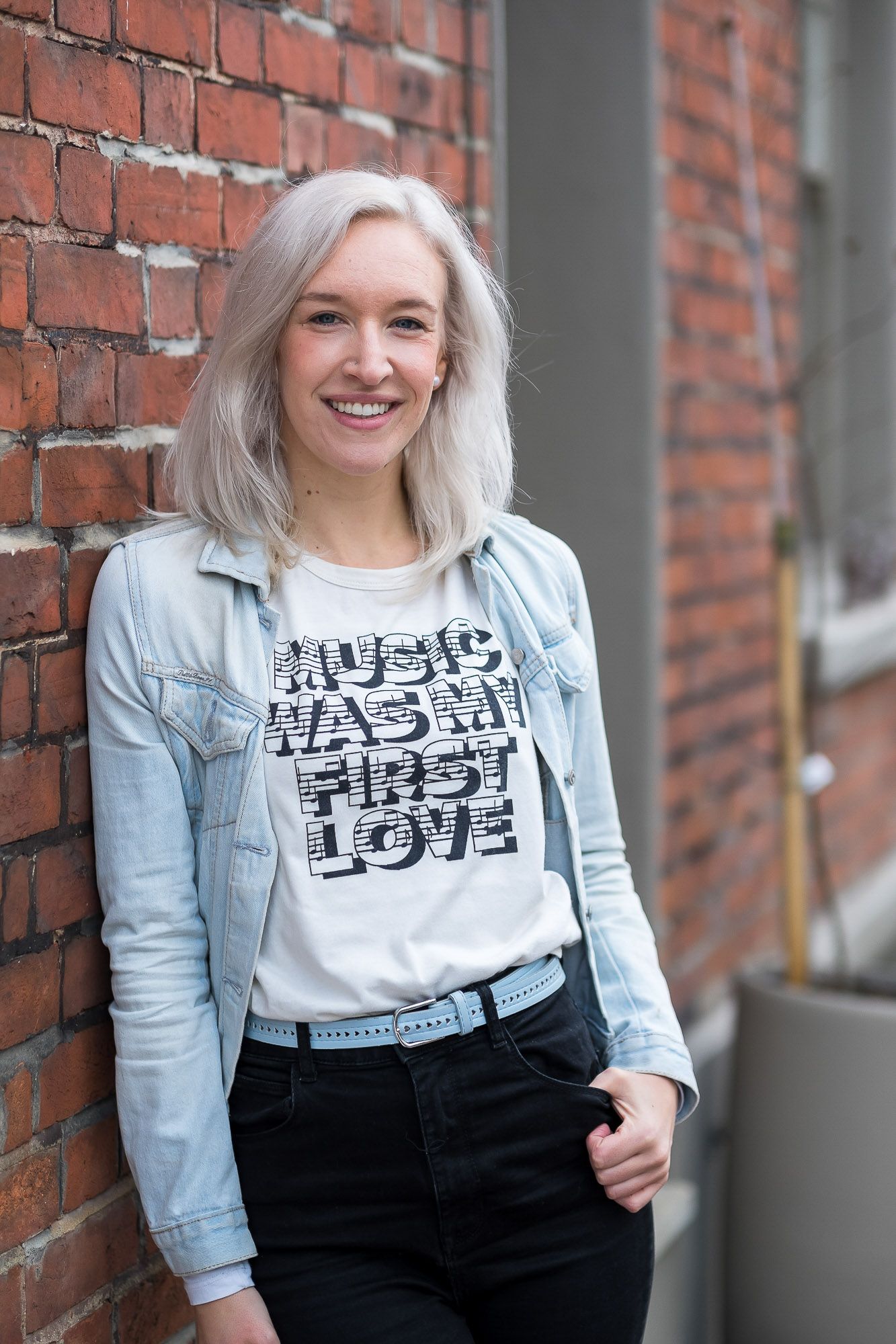 Music teacher Rosie Secker standing in the street in Brighton smiling 