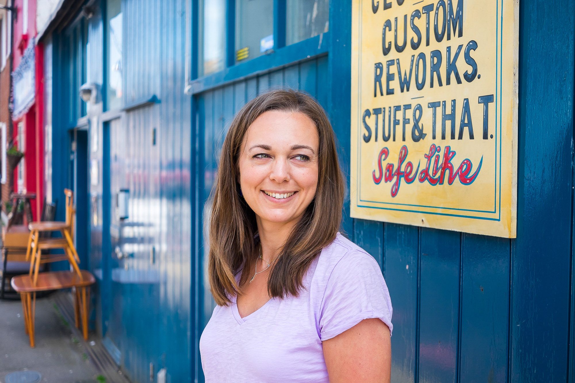 Woman standing in front of a blue shop front in Brighton