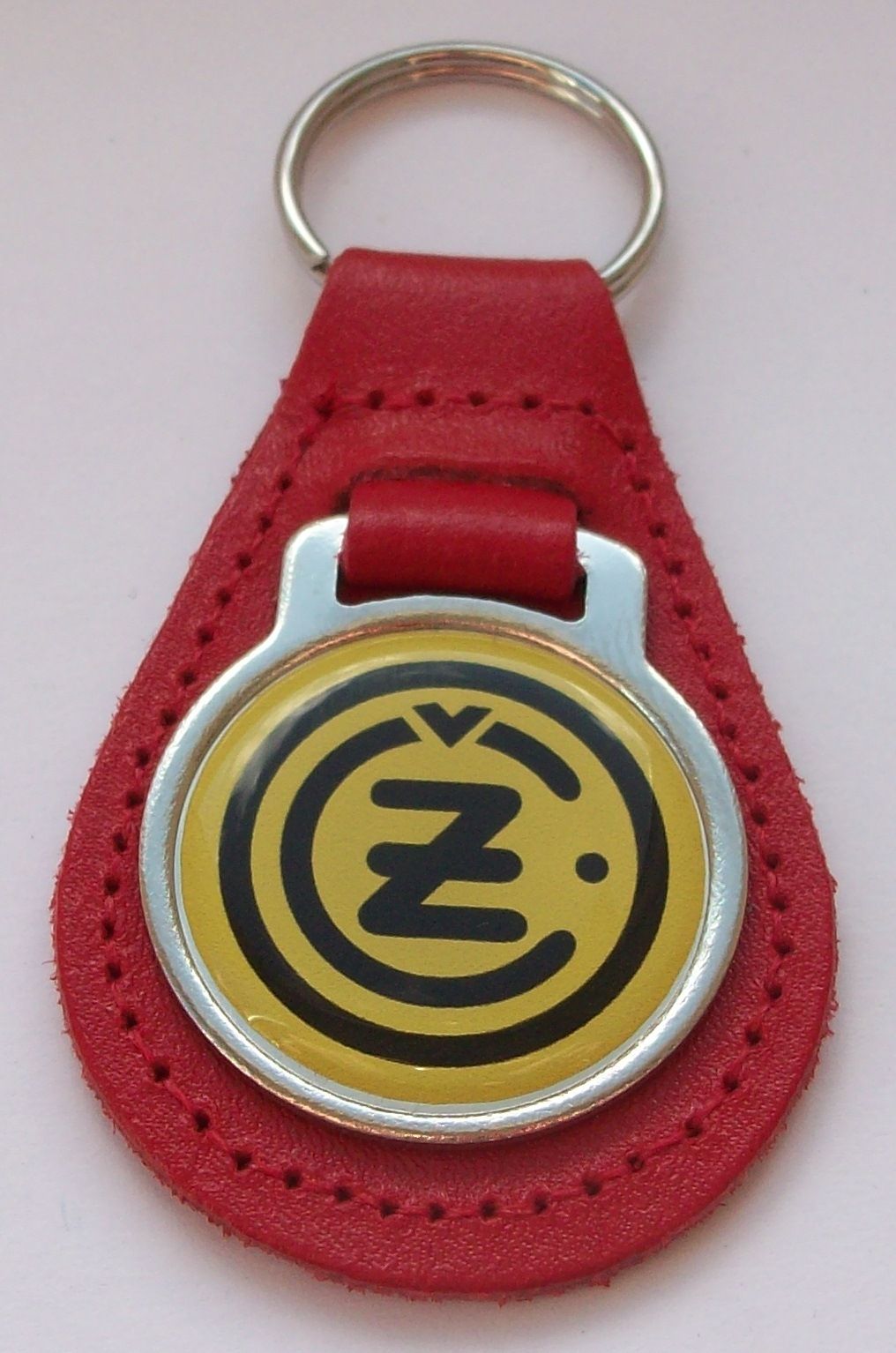 CZ acrylic badged red leather keyring.