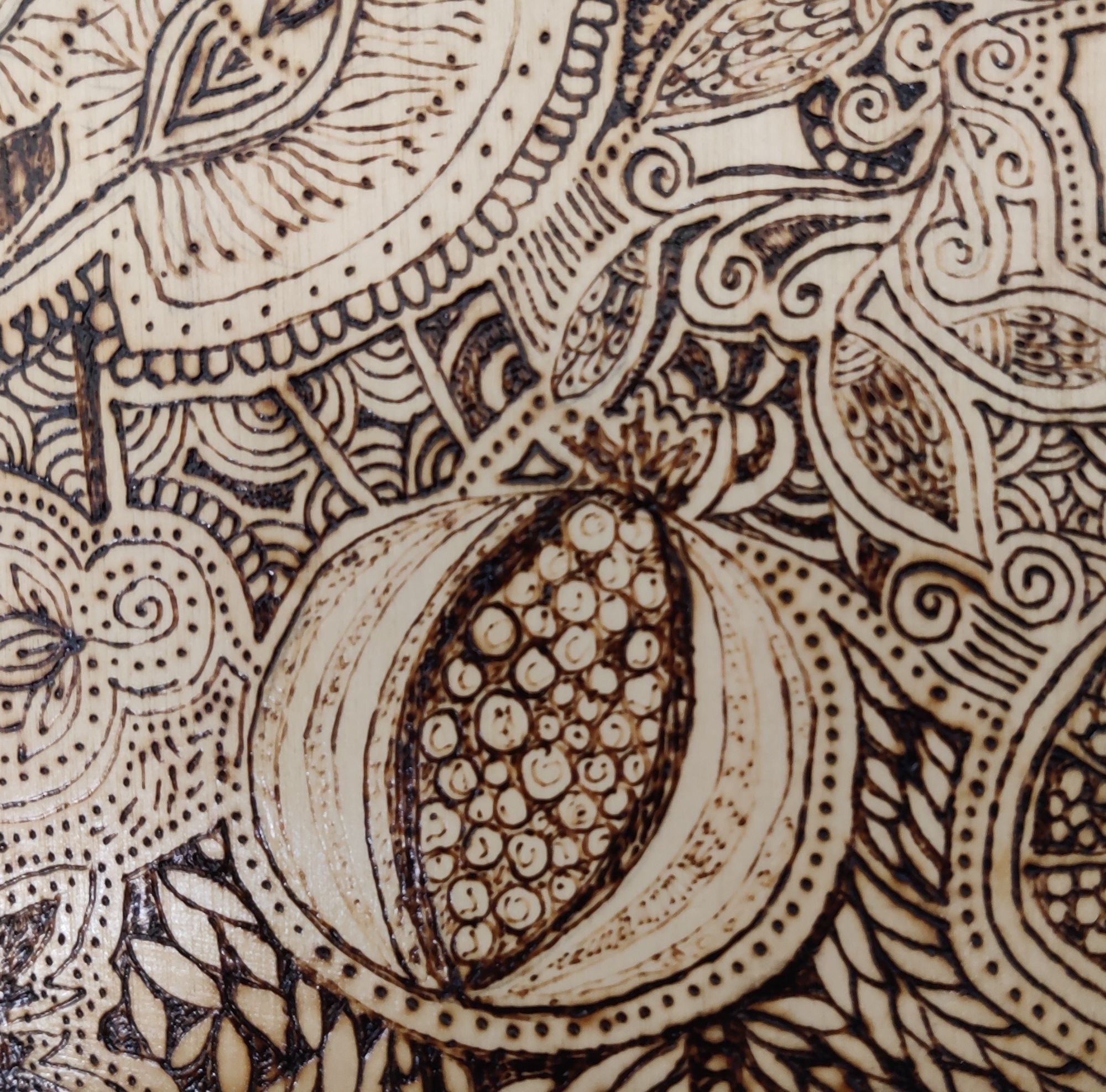 pyrography detail on wood panel