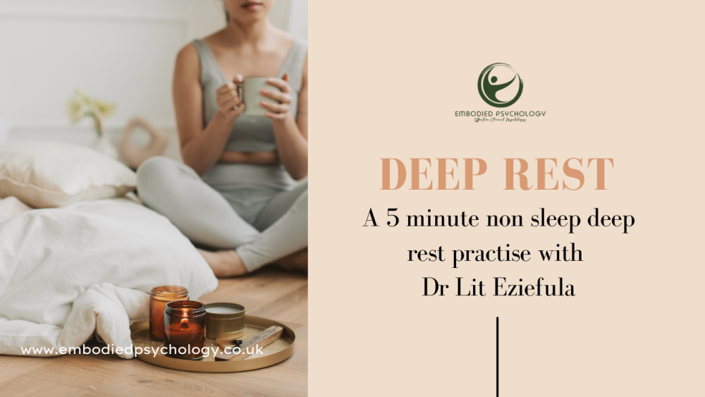 A woman sits crossed legged holding a mug a tray with a candle sits on the floor in front of her - title caption reads Deep Rest a 5 minute non sleep deep rest practice