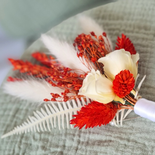 orange and white dried flower buttonhole