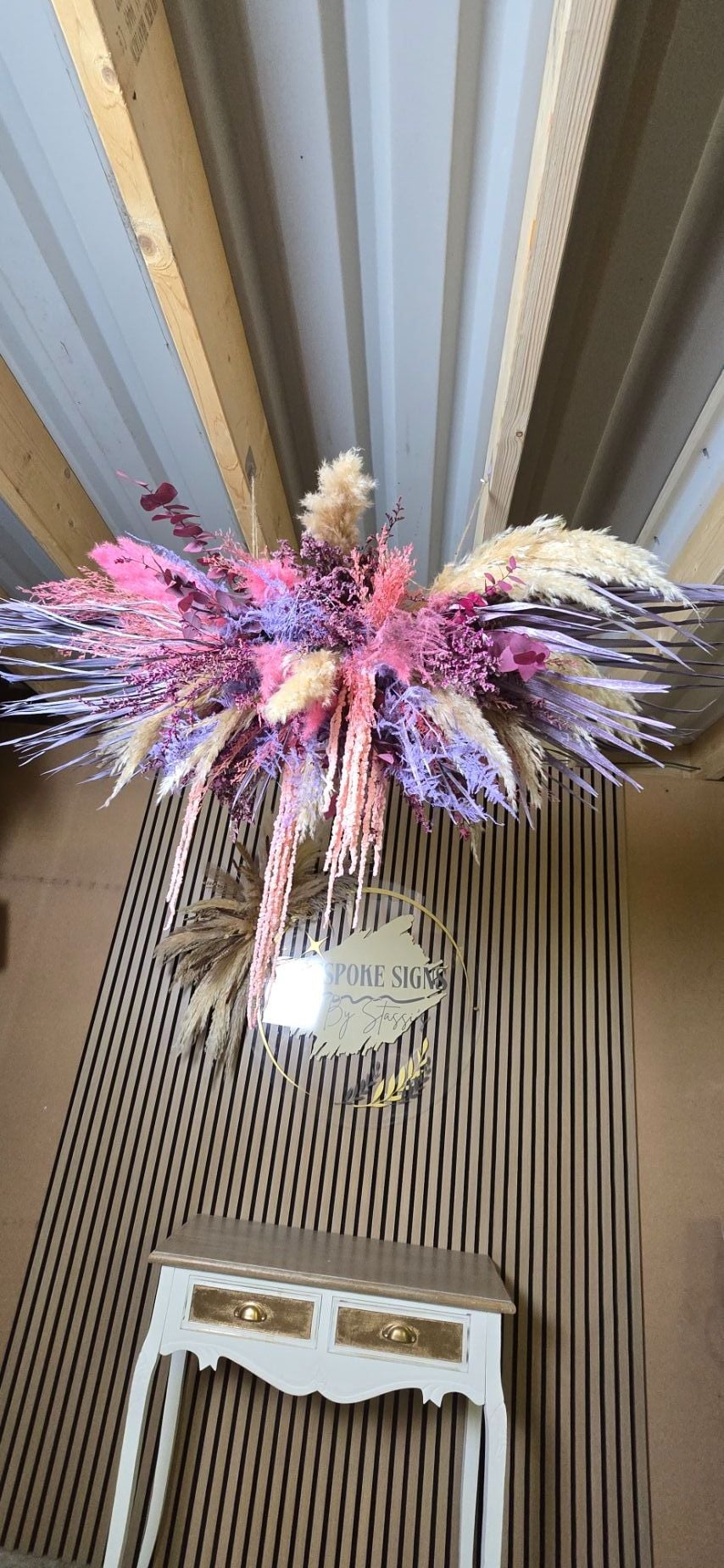 pink and purple dried flower suspended chandelier arrangement