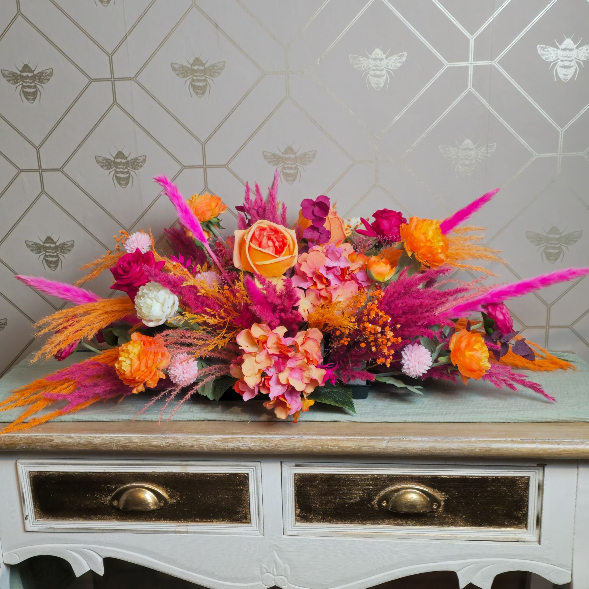 dried flower wedding centrepiece, in orange and pink