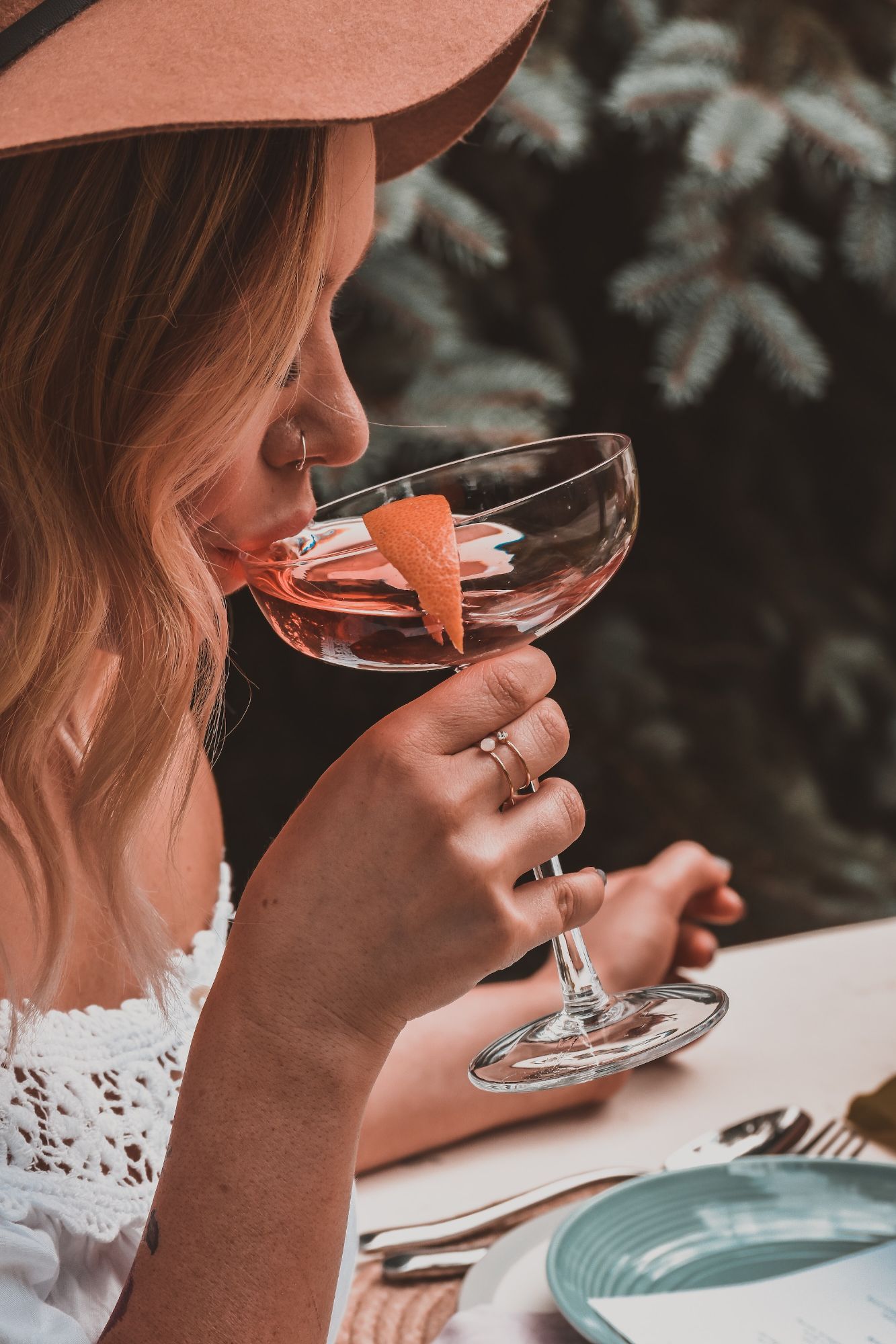 woman-holding-cocktail-glass-CTNUH5dCTkU.jpg