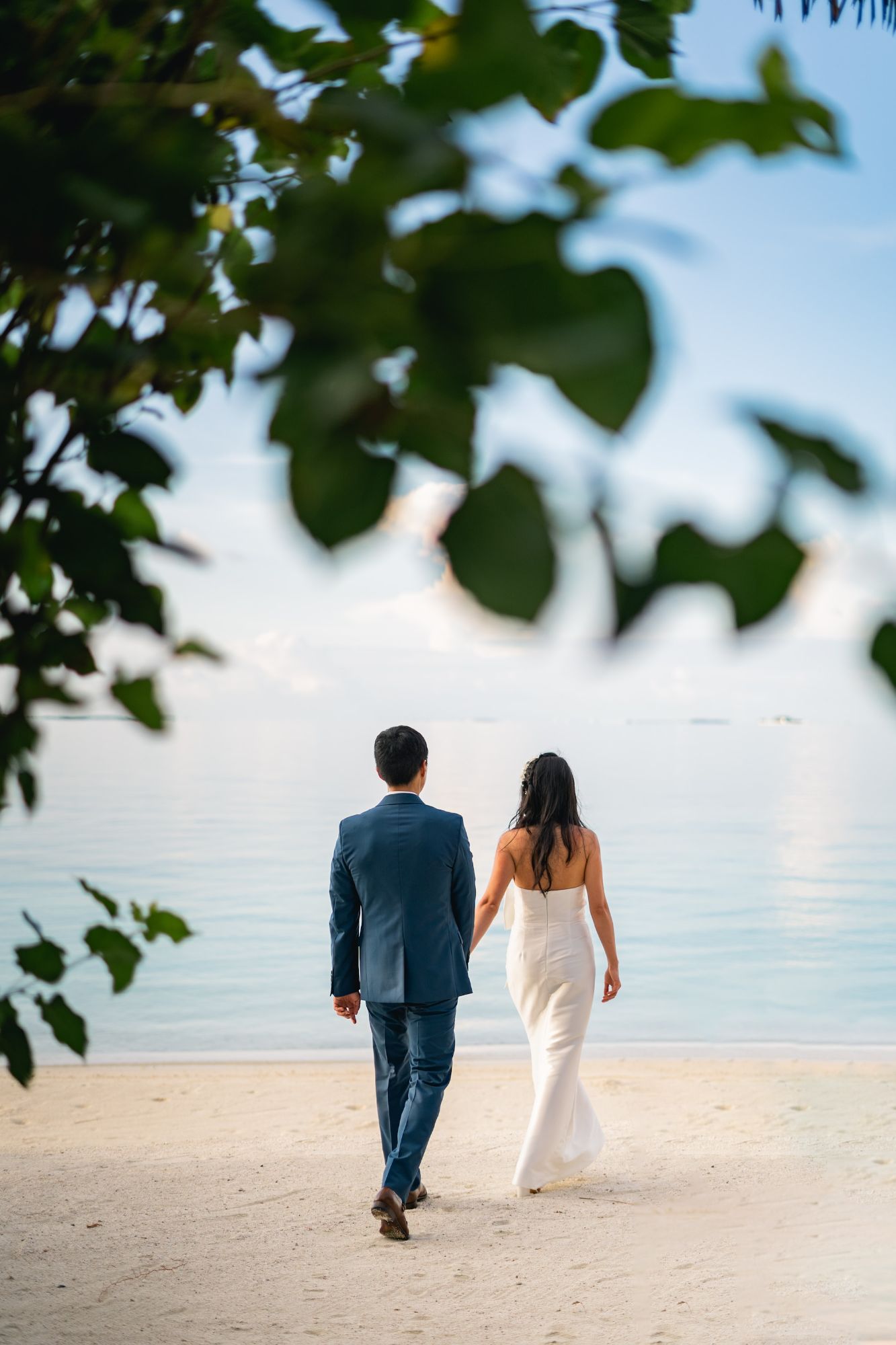 a-man-and-woman-walking-on-a-beach-qXg9TjUJZos.jpg