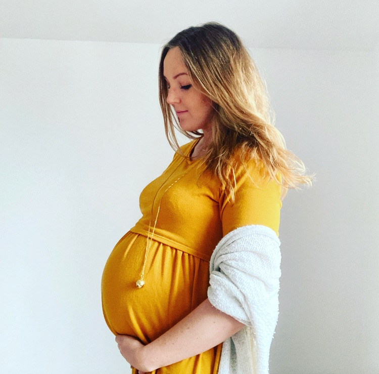 hypnobirthing bexley - relaxed pregnant woman looking at her bump