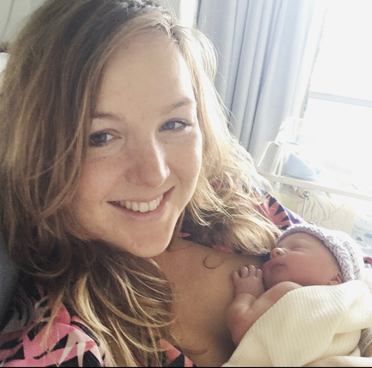 the hypnobirthing teacher after the birth of her first baby - the baby is sleeping on her chest and the mother is relaxed and smiling