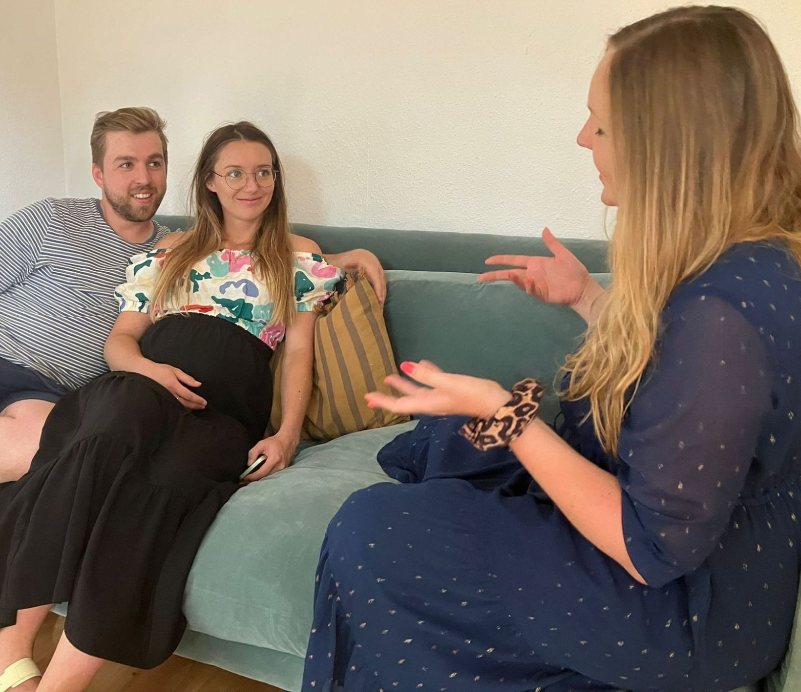 Birth Preparation course - a pregnant couple are sitting together on a sofa looking at their hypnobirthing teacher