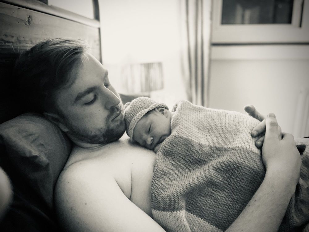 New Dad and newborn son after their hypnobirthing homebirth in London
