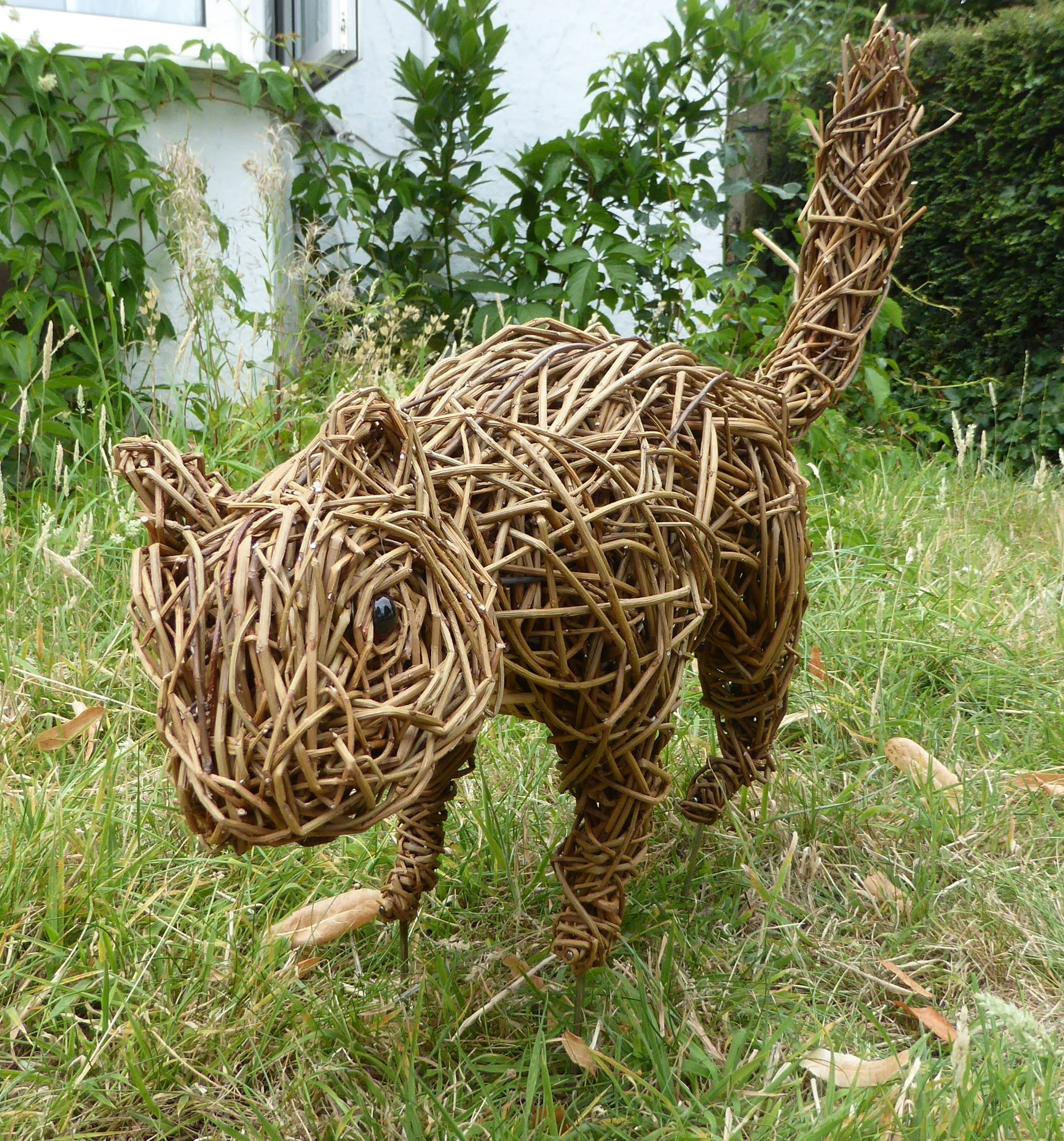 wilow squirrel sculpture standing on grass facing forward
