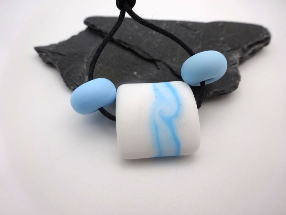white and blue wrapped pillow