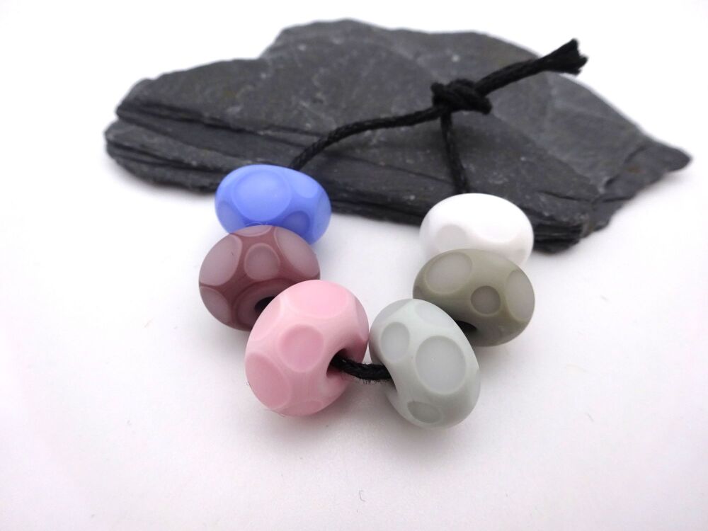 grey, pink and blue tumbled spots