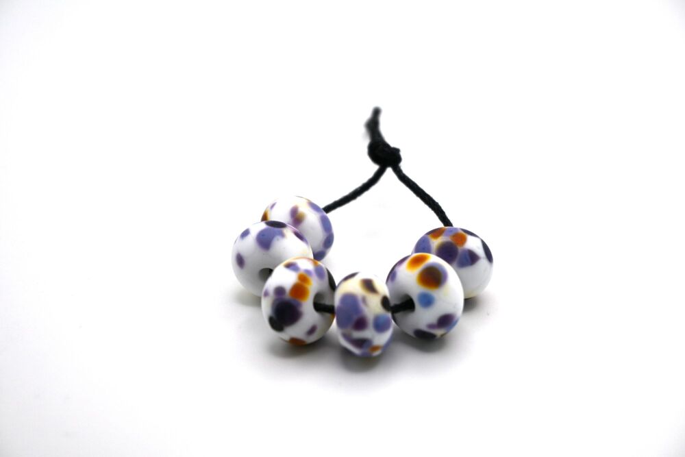 white and purple frit tumbled