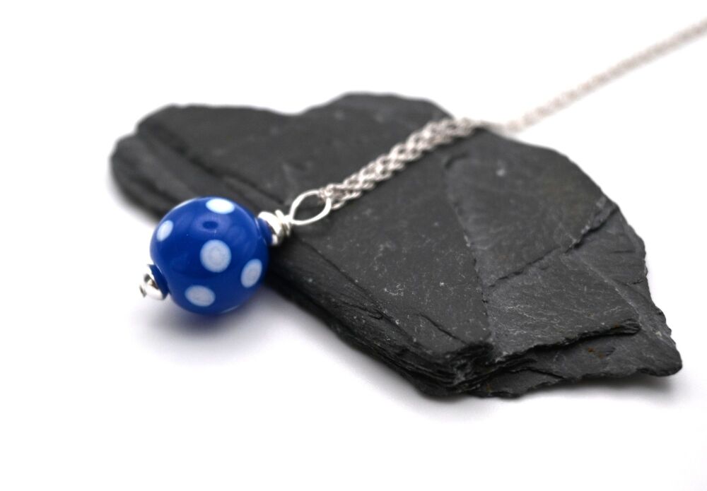 dark blue and white polka dot sphere