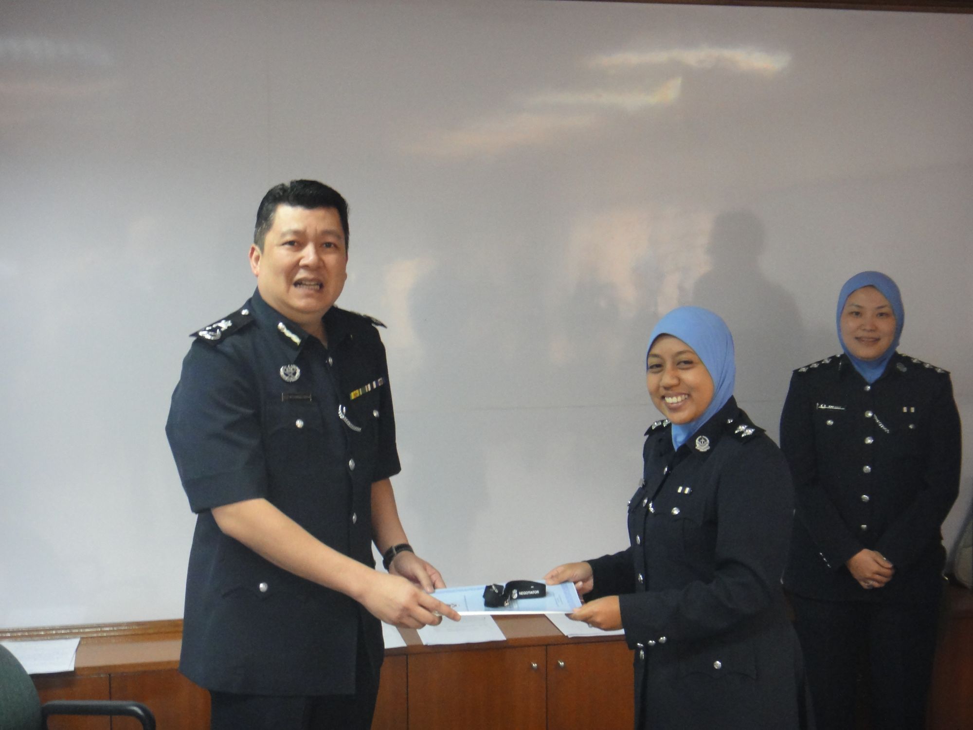 Certificates of completion and awards for HN course in Brunei awarded by the Now Commissioner of Police Dato Irwan Hambali. 