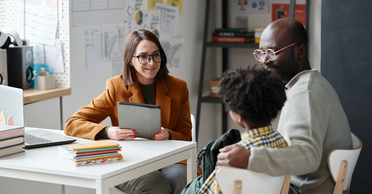 teacher guiding a parents evening with parent and student