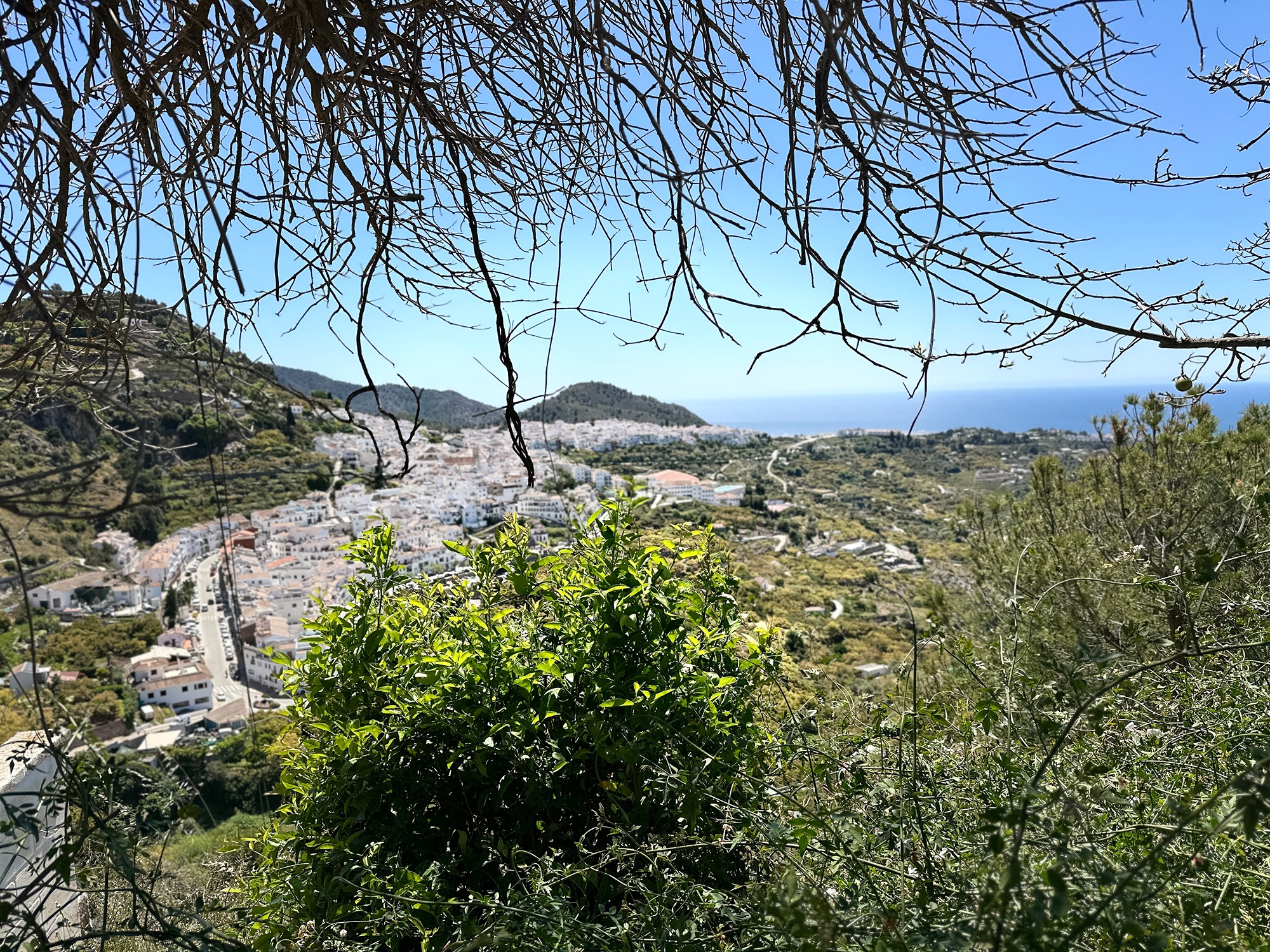 A scenic view of the rugged Sierra de Tejeda mountains and hiking trails surrounding the ghost village of El Acebuchal near Frigiliana, Spain.