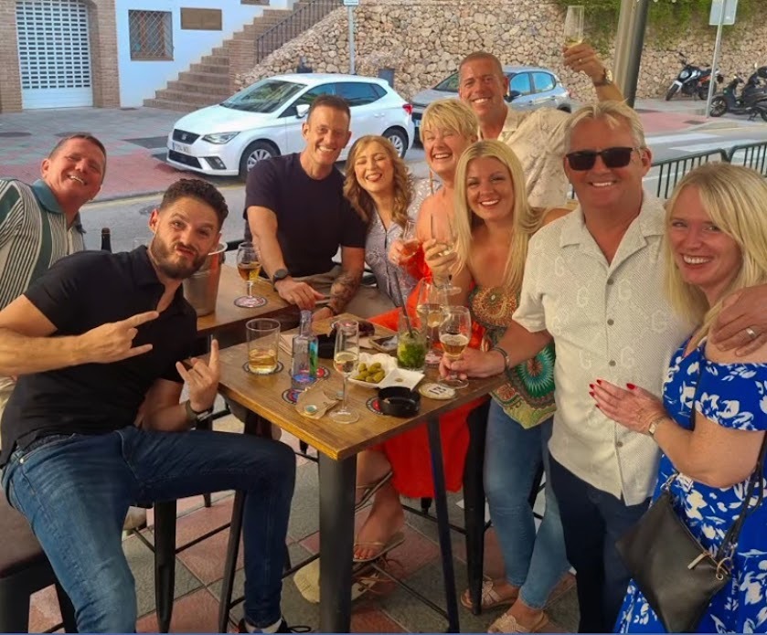 A group of British ex-pats gathered around a table in Frigiliana, Spain, sharing a bottle of Davison & Brogan gin and celebrating their own Place in the Sun.