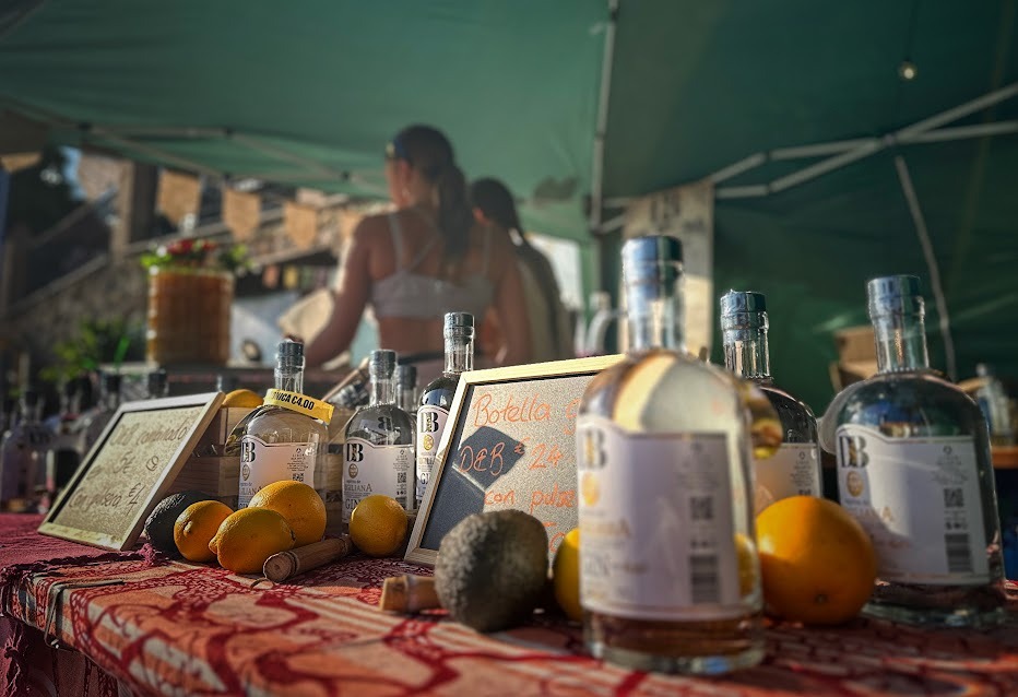 The bustling Frigiliana weekly market showing stalls of artisan Spanish products and local crafts.