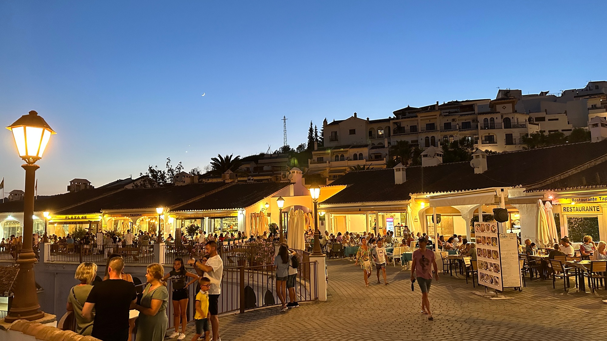 Avery busy plaza de la tres culturas Frigiliana, people walking, talking and enjoying frigilianas market centre