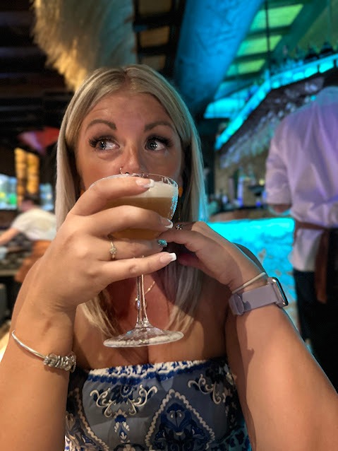 Close-up of a person enjoying a craft cocktail at a stylish M&Atilde;&iexcl;laga bar with ambient lighting