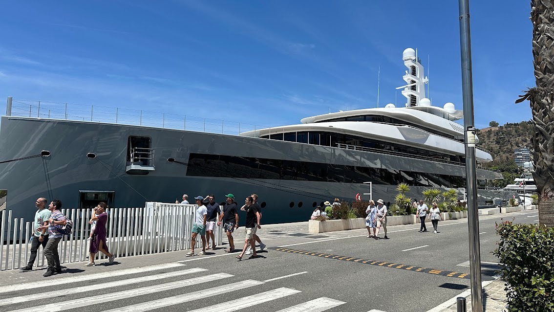Luxury superyacht docked at Muelle Uno, Port of M&Atilde;&iexcl;laga, under a clear blue sky